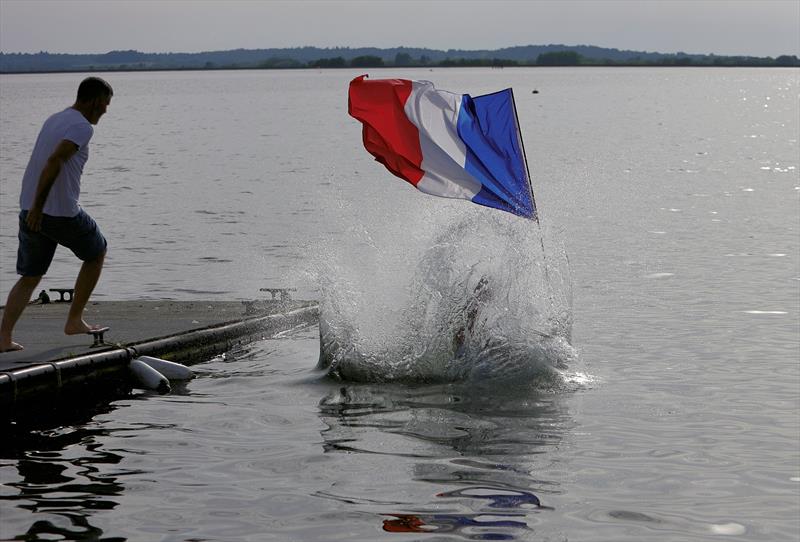 The winners celebrating with a dunk at the 2026 IOM Worlds - Alexis holding the French flag - photo © Mark Jardine