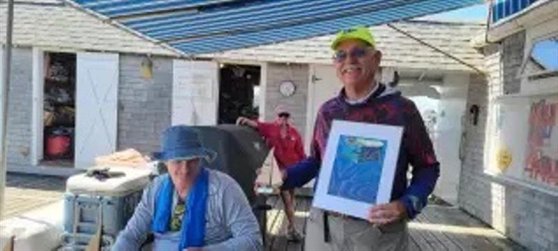 US Class Vice President John Seepe gets a 3rd place trophy photo copyright Michelle Seepe taken at Sandy Bay Yacht Club and featuring the 2.4m class