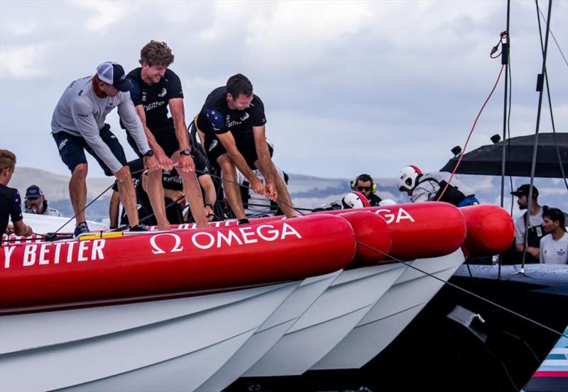 American Magic Grinder Sean Clarkson (left) works alongside ETNZ Helmsman Peter Burling and dozens of others to secure PATRIOT and prevent her from sliding further into the water - photo © Sailing Energy / American Magic