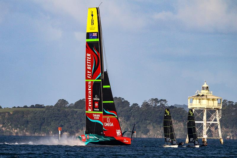 America's Cup Champion Te Rehutai concludes its final sailing day in Auckland, passing Bean Rock and two Olympic 49ers - May 2023 - photo © Richard Gladwell - Sail-World.com / nz