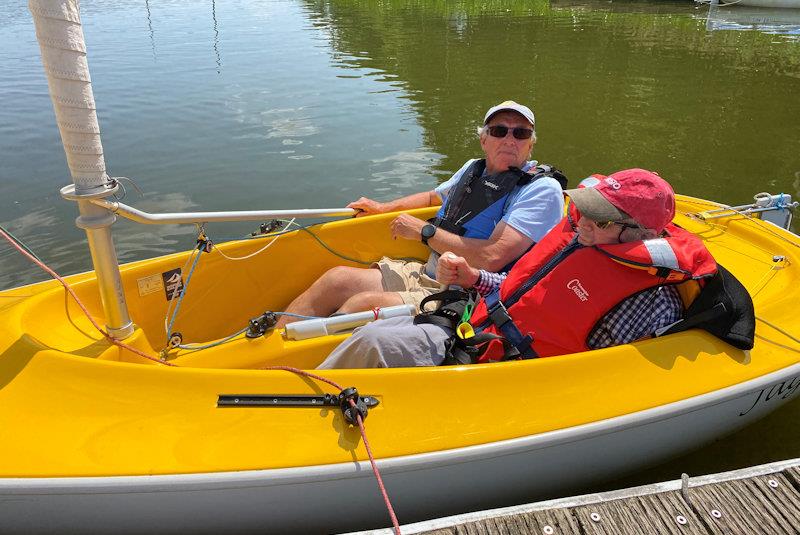 Hoist process step 6 - the hoist is detached, and the sling (black fabric on right of photo) can be left under the sailor photo copyright Magnus Smith taken at Frensham Pond Sailability and featuring the Hansa class