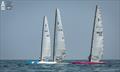 Charles Bueche SUI 65, Paulo Penco ITA 3 and Thijs Visser NED 33 ponder their life choices - A-Class Cat European Championships at Riccione Day 4 © Gordon Upton / www.guppypix.com