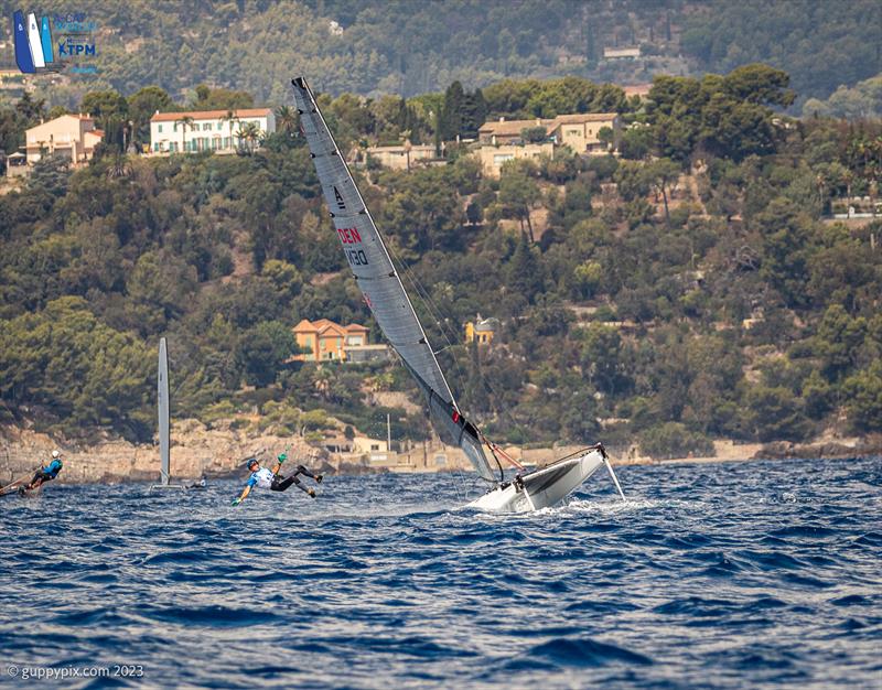 A-Cat Worlds at Toulon, France Day 5 - The unfortunate Viking Warrior Jan takes a trip around the mast on a wavy downwind leg - photo © Gordon Upton / www.guppypix.com