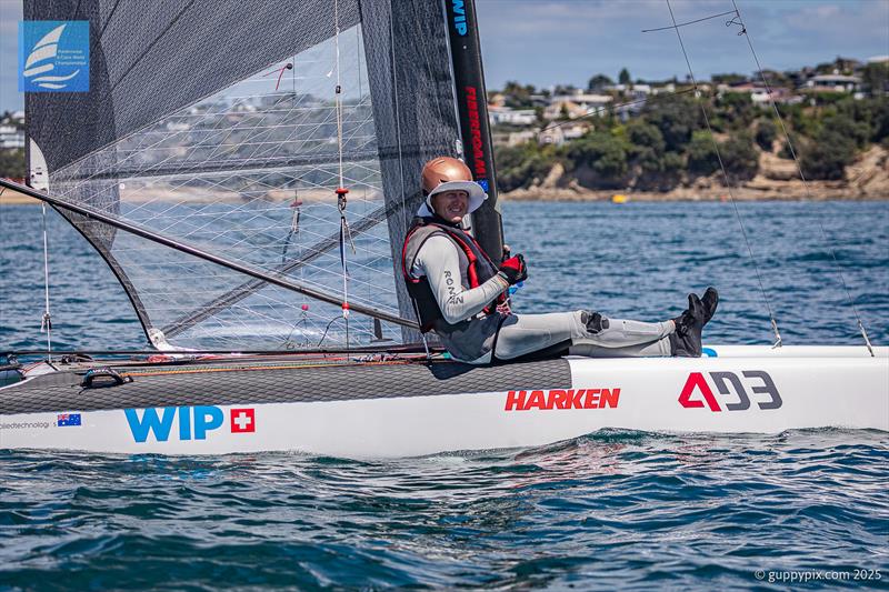 Stevie Brewin keeps off the hot Kiwi sun .- Day 5 Predictwind A-Class Catamaran World Championships - Milford, NZ - November 16, 2025 - photo © Gordon Upton / www.guppypix.com