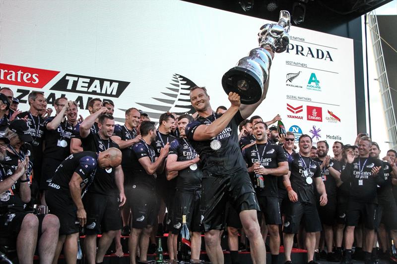 Grinder Steven Fergusson lifts the Cup high - Emirates Team NZ - America's Cup - Day 7 - March 17, 2021 photo copyright Richard Gladwell / Sail-World.com taken at Royal New Zealand Yacht Squadron and featuring the ACC class