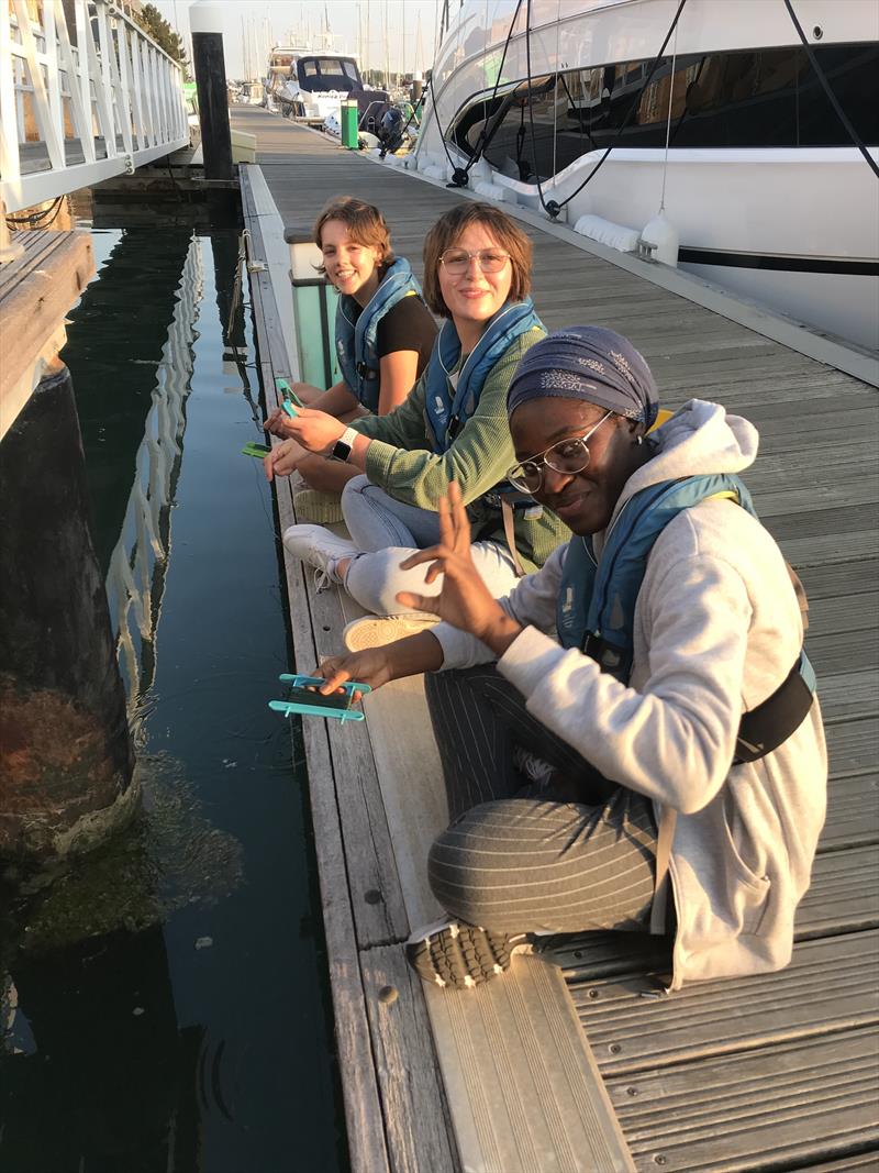 Sailors taking time out for a spot of crab catching while alongside photo copyright Ellen MacArthur Cancer Trust taken at  and featuring the  class