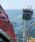 Phoenix YC's Quartette takes a dive boat on a tow after a Pan-Pan call © PYC