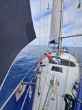 Spinnaker in light winds with the crew on deck relaxing