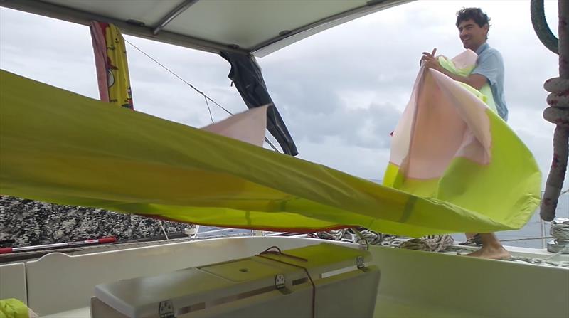 Packing the poor old spinnaker away - photo © Mission Ocean