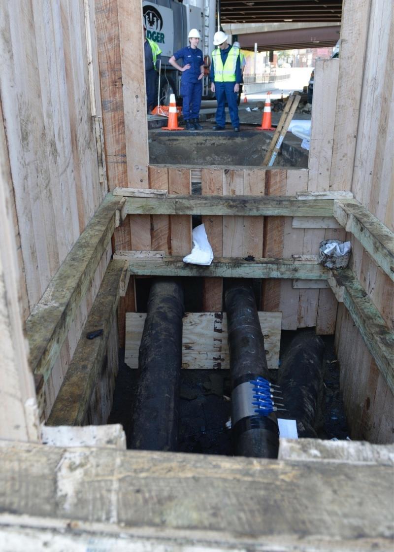 Ensign Lucy Daghir and Petty Officer 1st Class Alexander Shunda observe and discuss the temporary clamp around the pip under the I-93 bypass in Somerville, Monday, May 7, 2018 photo copyright Nicole J. Groll / U.S. Coast Guard taken at  and featuring the Cruising Yacht class