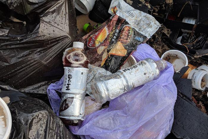 Plastic bags, bottled drinks and jars of emu oil are among the debris - photo © ABC News