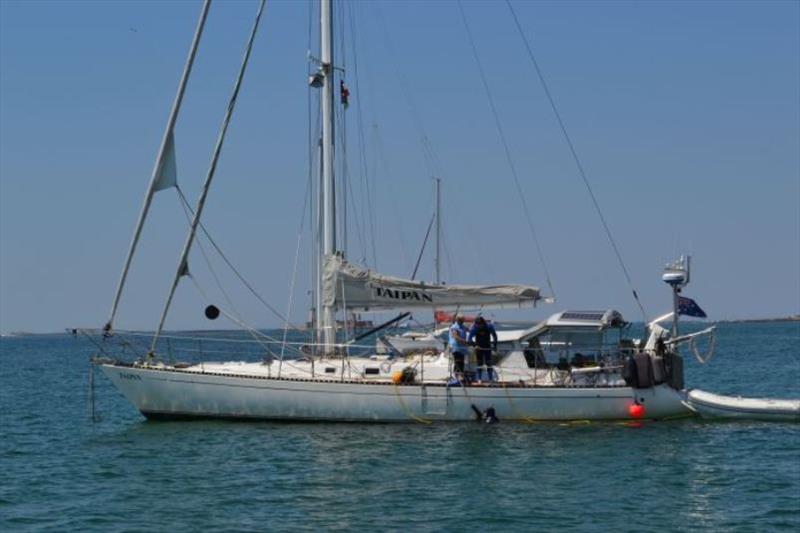 Kris attaching David to scuba hose, Maree already in the water ready to clean the hull of Taipan photo copyright SV Red Roo taken at  and featuring the Cruising Yacht class