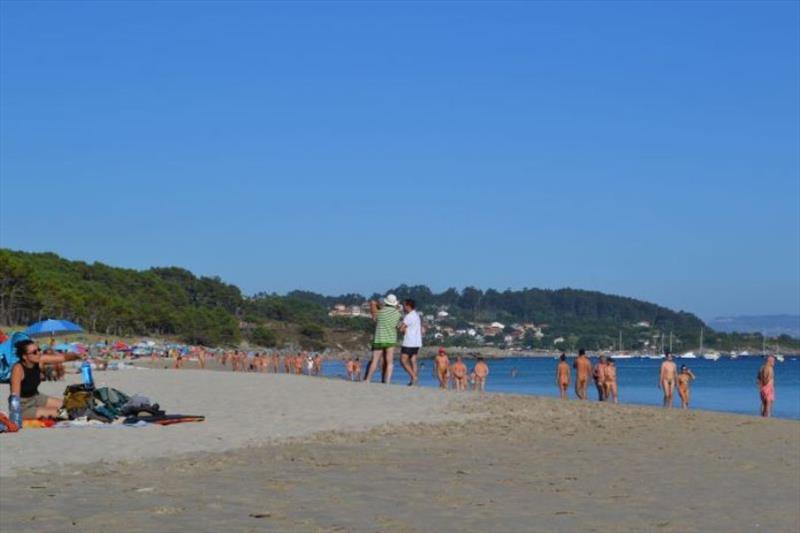 The view from shore, lots of people walking (or parading) along the beach photo copyright SV Red Roo taken at  and featuring the Cruising Yacht class