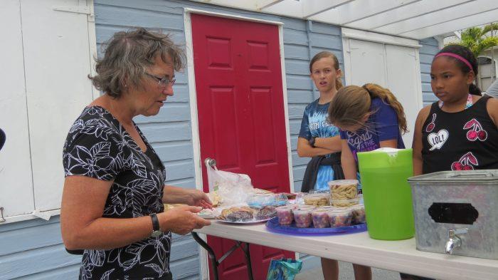 Man-O-War Cay: Our hostess, Connie van Bussel, negotiates for cookies from schoolkids saving for a trip to Eleuthera photo copyright Stephen and Nancy Carlman taken at  and featuring the Cruising Yacht class