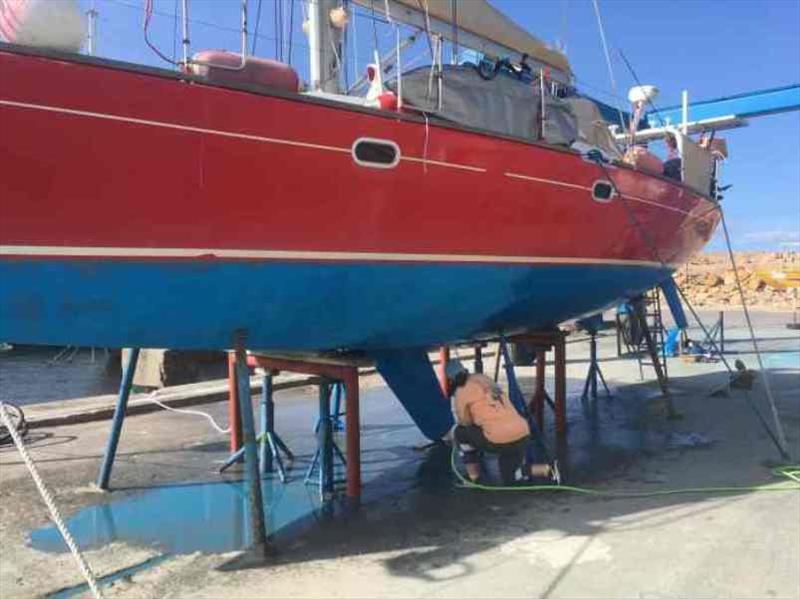 Washing after sanding and before the new white goes on photo copyright Red Roo taken at  and featuring the Cruising Yacht class