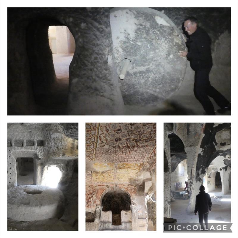 Keslik Monestery all carved into caves in the hillside. Jean trying to work the old stone circle door (hint to Jean, it is locked open with the stick in the middle) - photo © SV Red Roo