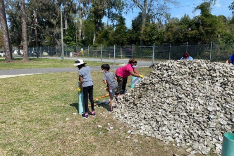 Volunteers bagging oyster cultch, a substrate that helps oysters grow, at the Savannah State University Marine Science Research Center photo copyright Savannah State University/Cameron Atkinson taken at  and featuring the Cruising Yacht class