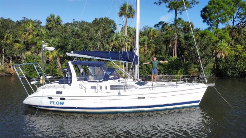 Captain Cade Moore of “Flow” on the morning after Hurricane Nicole, celebrating on the bow of undamaged boat, grateful to the nearby mangrove trees for their shelter during the night before when the storm gusted through at 70 plus mph photo copyright Cade Moore taken at  and featuring the Cruising Yacht class