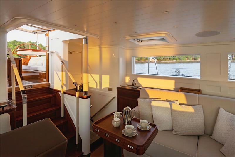 Ouzel, a 95ft superyacht - A sunlit seating nook aboard Ouzel opens directly to the companionway and cockpit above - photo © Russell Kaye