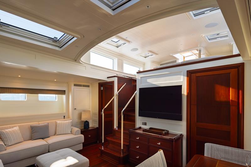 Ouzel, a 95ft superyacht - An alternate view of Ouzel's main saloon shows the companionway, mahogany cabinetry, and natural light from the pilothouse above - photo © Russell Kaye