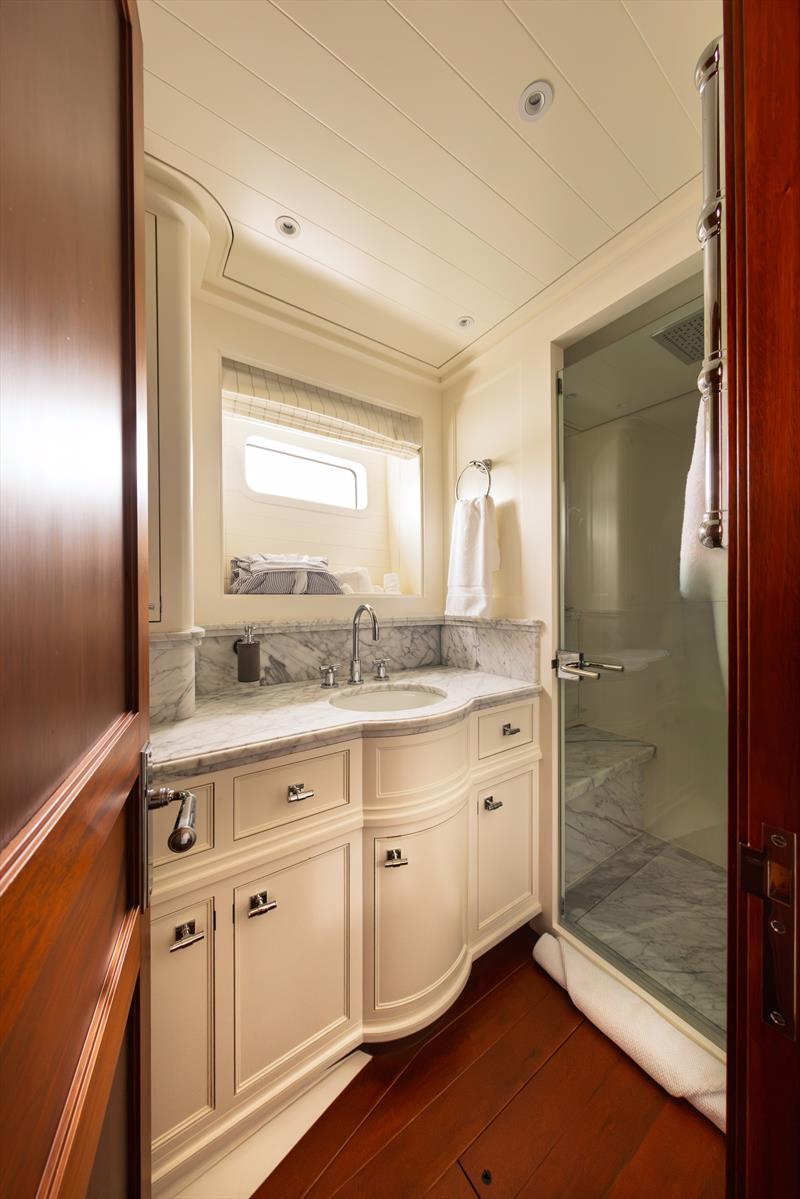 Ouzel, a 95ft superyacht - An en suite head aboard Ouzel pairs a marble vanity with a separate glass-enclosed shower photo copyright Russell Kaye taken at  and featuring the Cruising Yacht class