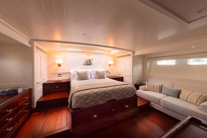 Ouzel, a 95ft superyacht - The owner's stateroom aboard Ouzel features a centerline berth, built-in settee, and extensive mahogany cabinetry - photo © Russell Kaye