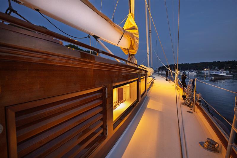 Teak woodwork leads forward past Ouzel's pilothouse at night - photo © Russell Kaye