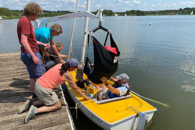 Hoist process step 4 - watch where the feet are going, as well as the torso, so the feet can be guided into place without tangling photo copyright Magnus Smith taken at Frensham Pond Sailability and featuring the Dinghy class