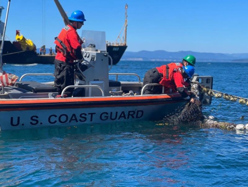 A U.S. Coast Guard team removing the floating netting on August 24, 2022 - photo © U.S. Coast Guard