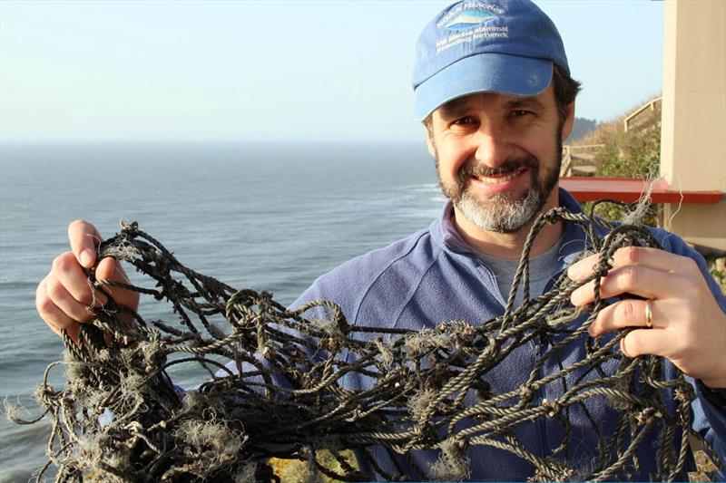 Jim Rice holds up the remains of a trawl net that the OSU team removed from an entangled Steller sea lion (Eumetopias jubatus) - photo © Oregon State University