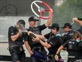 The New Zealand SailGP Team crew spray each other with Champagne Barons de Rothschild on board their F50 after winning the final race on Race Day 2 of the Singapore Sail Grand Prix © Bob Martin/SailGP