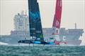 New Zealand SailGP Team  and Denmark SailGP Team battle in thew foreground of a cargo ship on Race Day 2 of the Singapore Sail Grand Prix  © Eloi Stichelbaut/SailGP.