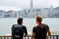 Blair Tuke and Erik Heil looking out at Victoria Harbour in Hong Kong - 2027 Season Venues announcement - SailGP - May 20, 2026 &copy; Keith Tsuji