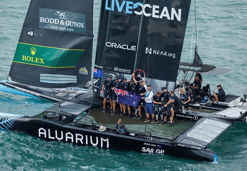 LI Quanhai, President of World Sailing hands the trophy to Peter Burling on board the F50 following their victory in the final race on Race Day 2 of the Singapore Sail Grand Prix  - photo © Ian Walton/SailGP.