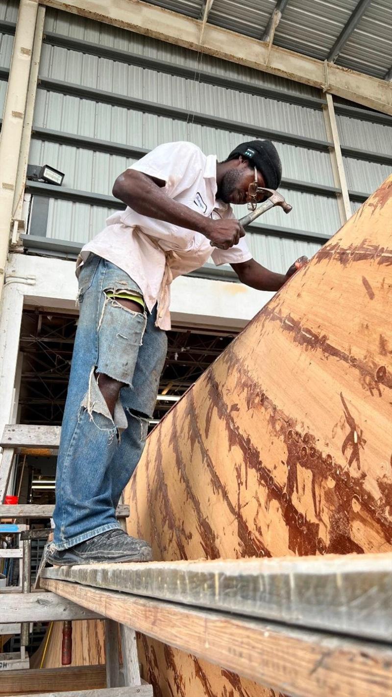 Sherwayne making a fashion statement while planking Hull #8 - photo © Michael Rybovich & Sons