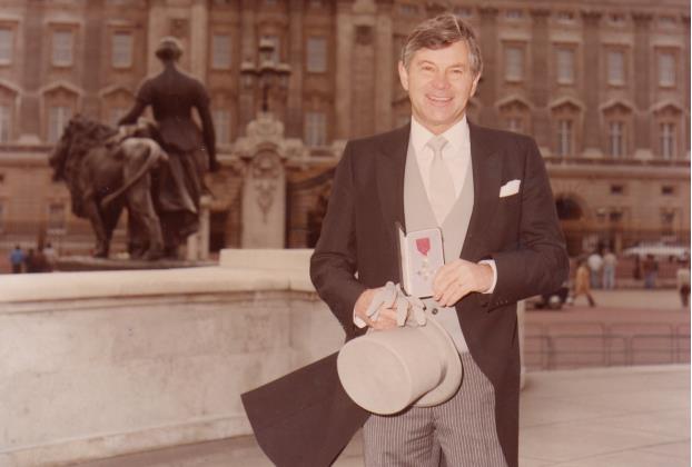 Queen Elizabeth II awards Mr Henri the MBW for his contributions to the clothing industry in 1985 - photo © Henri-Lloyd