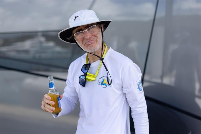 Sam Manuard, designer of Palanad 4 enjoys an ice cold beer on arrival - photo © Arthur Daniel / RORC