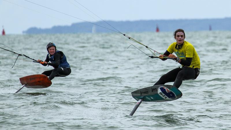 Justina Kitchen is chased out of the start by Hugo Wigglesworth - Day 3 - Kiteboards - Oceanbridge NZL Sailing Regatta - Takapuna BC February 19, 2022 photo copyright Richard Gladwell / Sail-World.com / nz taken at Takapuna Boating Club and featuring the Kiteboarding class