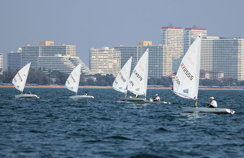 ILCA 6 fleet downwind with the Pattaya skyline in the background on day 1 of the Open Masters Championship 2026 - photo © James Young