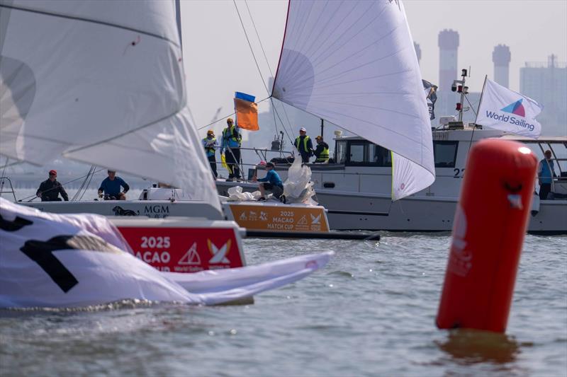 USA's Gavin Brady/ True Blue Racing crosses the line seconds ahead of USA's Chris Poole/ Riptide Racing - 2025 Macao Match Cup day 2 photo copyright Ian Roman / WMRT taken at  and featuring the Match Racing class