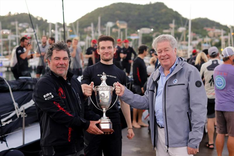 Andrew McIrvine, Secretary General of the IMA presents Mitch Booth, Skipper of Maxi 100 Comanche and Team Comanche with the fine vintage silver IMA Trophy awarded to the monohull line honours winner photo copyright Arthur Daniel / RORC taken at Royal Ocean Racing Club and featuring the Maxi class