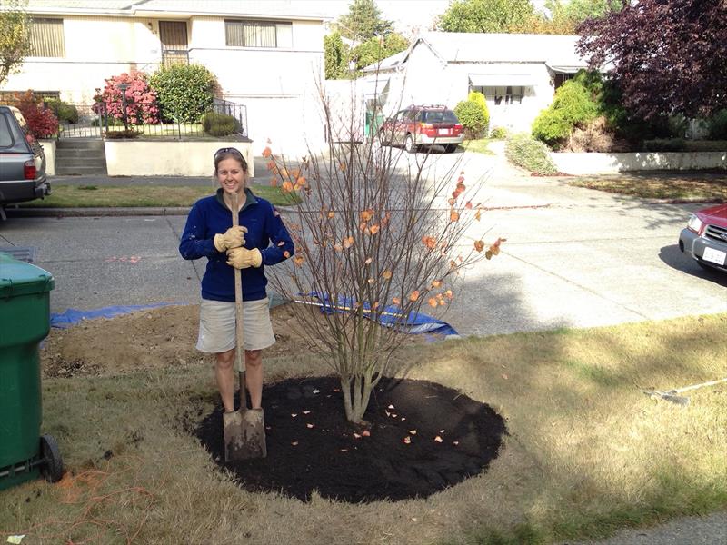 The author's wife, celebrating a successful tree planting in 2012 photo copyright David Schmidt taken at Bellingham Yacht Club