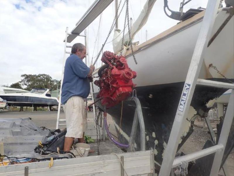 Engine on the deck - Loading engine onto the vehicle waining below - photo © livingourlifestyle.com