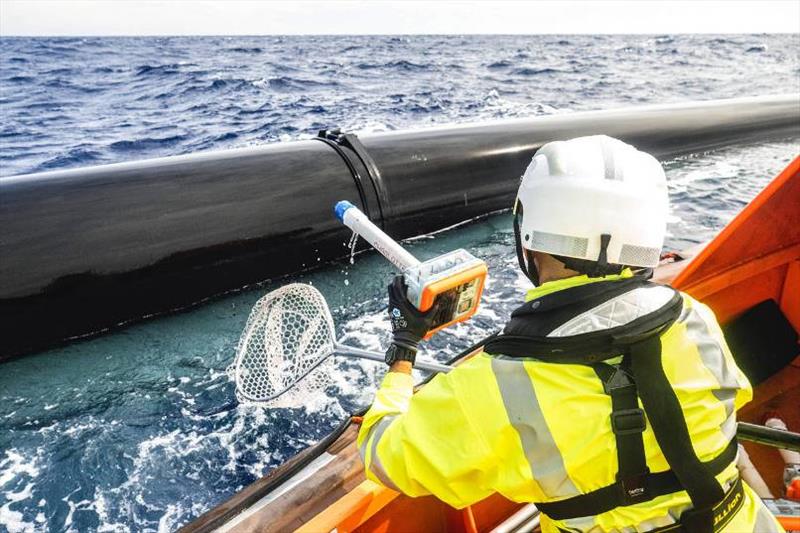 A crew member retrieves a GPS drifter from the water. - photo © The Ocean Cleanup