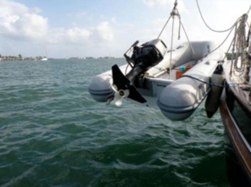 Hang the dinghy - look carefully, you can see the cable locking it to the boat. This was before we started separating the outboard from the inflatable. - photo © Commuter Cruiser