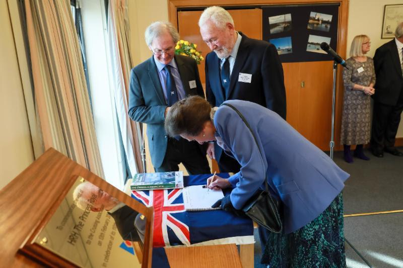 The Princess Royal signs the Visitors Book having unveiled a plaque to mark the CA's 110th Anniversary, accompanied by CA President Julian Dussek and CA Patron Sir Robin Knox-Johnston photo copyright Duncan Smith Photography taken at 