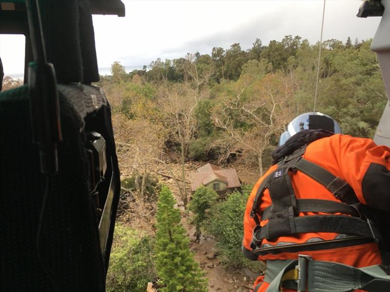 A crew member looks down on homes and street of a neighborhood affected by the Santa Barbara County mudslides in Santa Barbara, California, Jan. 9, 2019. - photo © Petty Officer 3rd Class DaVonte Marrow /  U.S. Coast Guard District 11 PADET