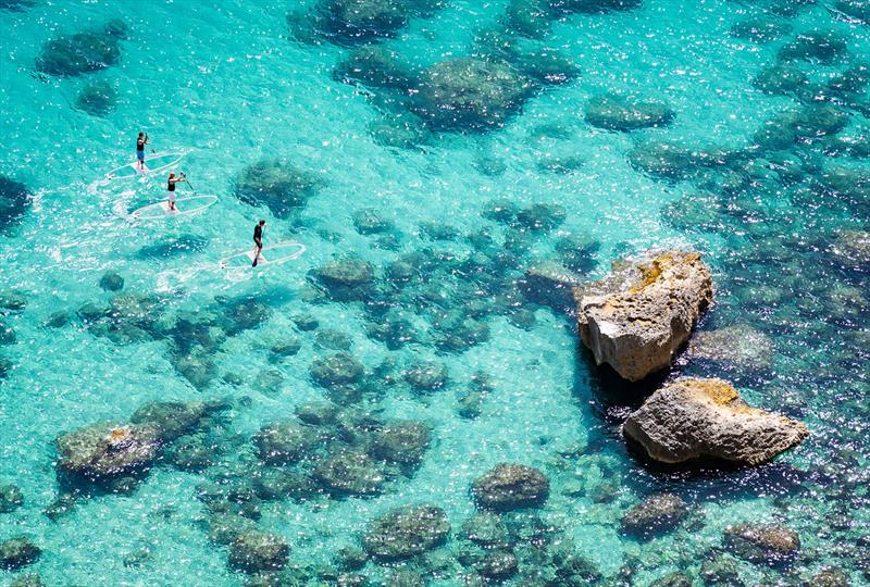 Sliding along - Stand Up Paddleboarding in the clear with the transparent Loeva SUP - photo © Stefano Garau