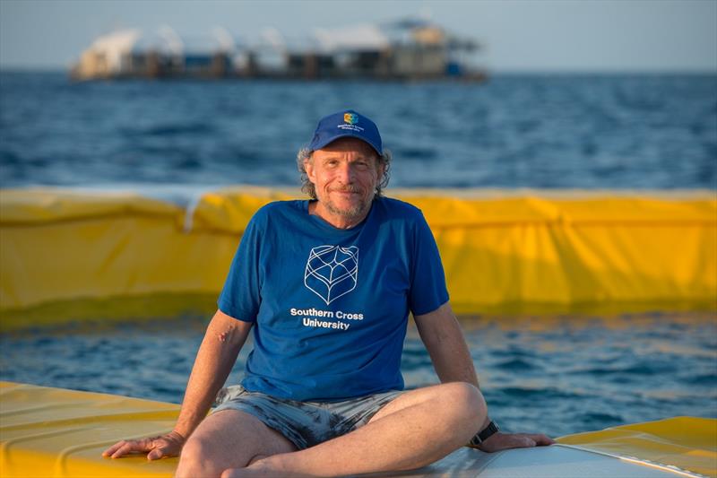 Professor Peter Harrison with a coral nursery larval pool, Moore Reef - photo © Juergen Freund