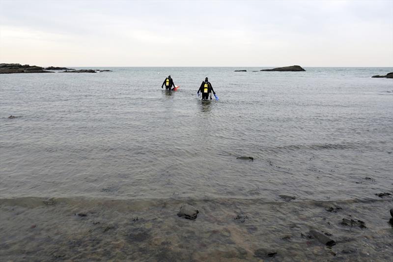 Sean Grace and Gabriella Dipreta wade into Long Island Sound to collect Astrangia corals photo copyright NOAA Fisheries taken at 